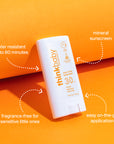 Thinkbaby SPF 30 mineral sunscreen stick on bright orange background highlighting water resistance, fragrance‑free formula, and easy on‑the‑go application.