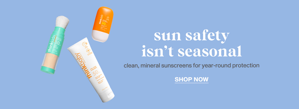 Three sunscreen tubes floating on a light blue background with the text 'sun safety isn't seasonal', 'clean, mineral sunscreens for year-round protection', and 'SHOP NOW'.