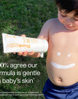 A young child is shown holding a tube of Thinkbaby SPF 50 sunscreen, with sunscreen applied in a smiley face pattern on the child's belly, accompanied by text saying '100% agree our formula is gentle on baby's skin.'