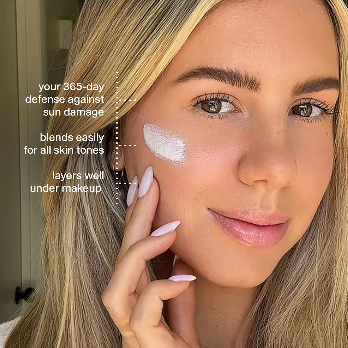 Woman applying sunscreen to her face with text highlighting its benefits