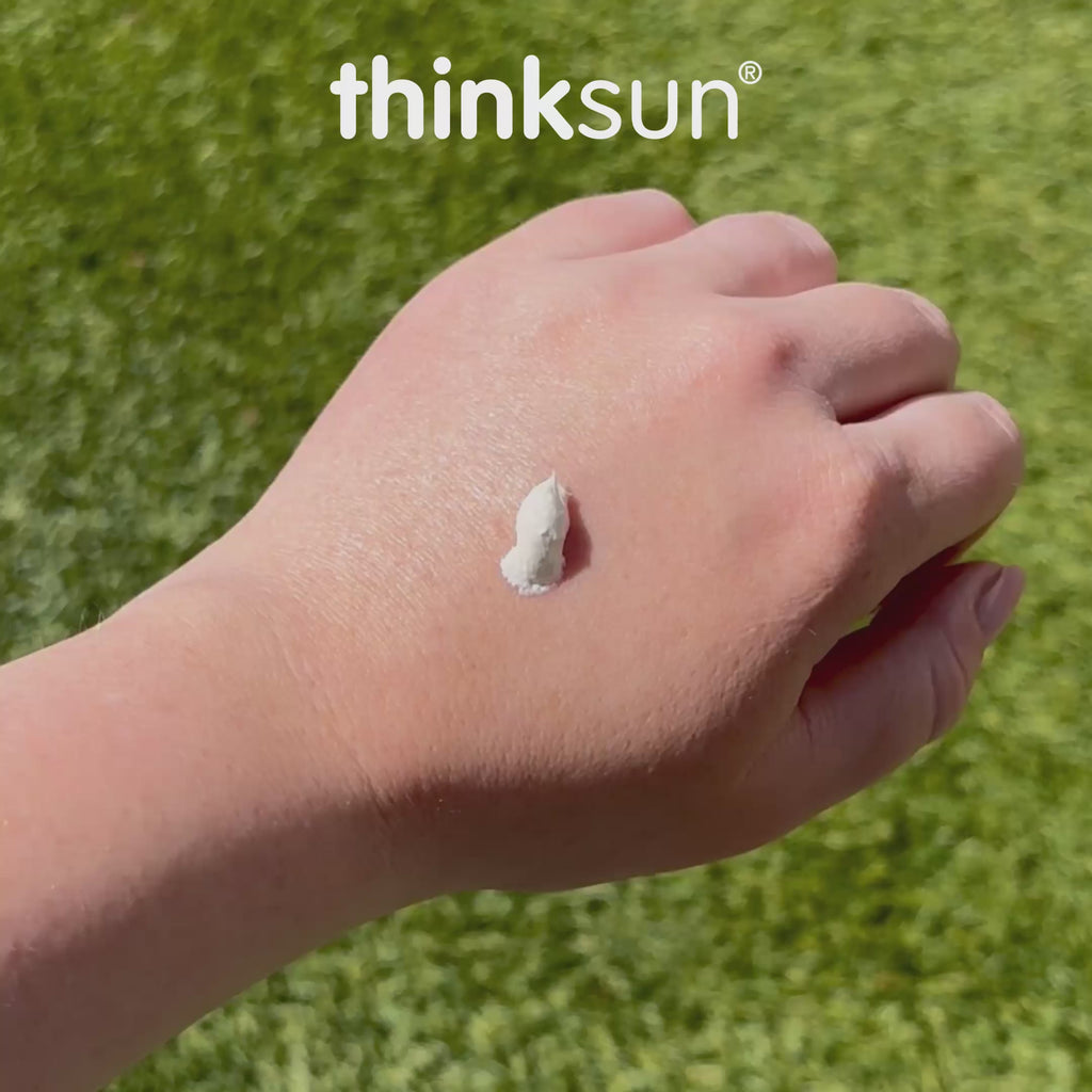 Thinksun mineral sunscreen cream texture applied on the back of a hand outdoors, demonstrating smooth, non‑greasy consistency and easy spread.