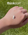 Thinksun mineral sunscreen cream texture applied on the back of a hand outdoors, demonstrating smooth, non‑greasy consistency and easy spread.